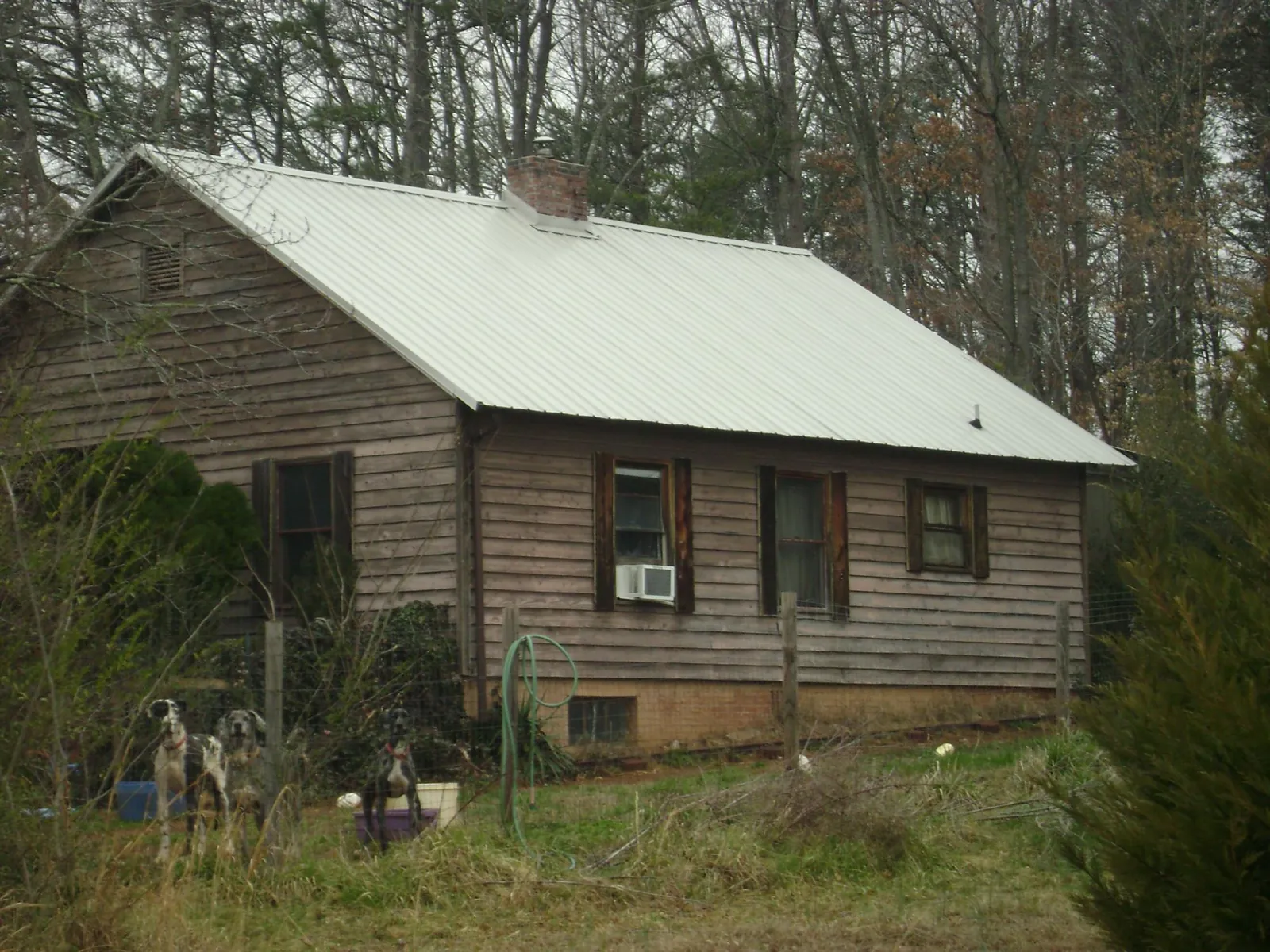 White metal roof on an old wood sided farmhouse, from a Metal Roof Installation job in Cheney
